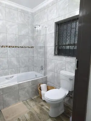 a bathroom with a toilet and a bath tub at Molas Luxury Accomodation in Ga-Mothiba