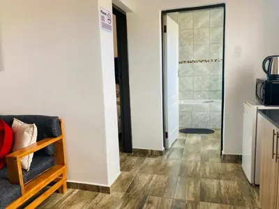 a room with a shower and a couch and a bathroom at Molas Luxury Accomodation in Ga-Mothiba
