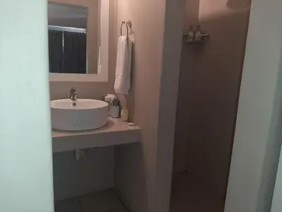 a bathroom with a sink and a mirror at St George's Guest House in Tzaneen