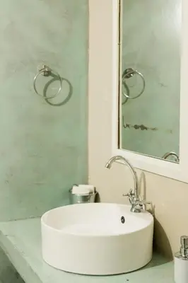 a bathroom with a white sink and a mirror at St George's Guest House in Tzaneen
