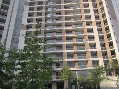 an apartment building with trees in the foreground at MENLYN MAINE - One Bedroom Penthouse - NO LOAD SHEDDING!! in Pretoria