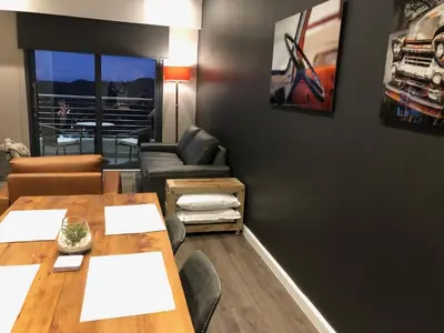 a dining room with a table and chairs at MENLYN MAINE - One Bedroom Penthouse - NO LOAD SHEDDING!! in Pretoria