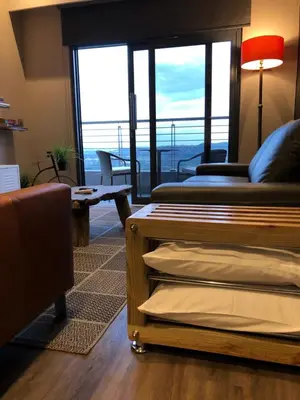 a room with a bed and a balcony with a view at MENLYN MAINE - One Bedroom Penthouse - NO LOAD SHEDDING!! in Pretoria