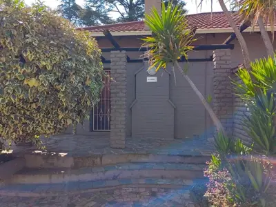 a house with a palm tree in front of it at Sibahlenomhlambi Guesthouse in Springs
