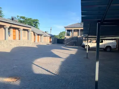 a car parked in a parking lot next to a building at The Hill Lodge in Thohoyandou