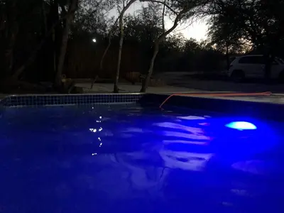 a swimming pool with blue lighting at night at Lion Hill @Kruger in Marloth Park
