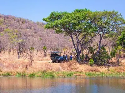 a truck parked next to a body of water at Metsi Lodge in Welgevonden Game Reserve
