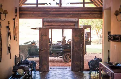 an open door with a truck parked in a room at Metsi Lodge in Welgevonden Game Reserve