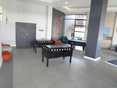 a living room with three tables and a pool table at The Blyde Crystal Lagoon Cologne4 in Pretoria