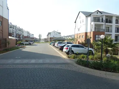 a street with cars parked on the side of the road at The Blyde Crystal Lagoon Cologne4 in Pretoria