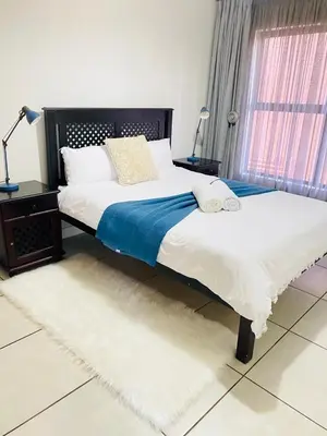 a bedroom with two beds and a window at The Blyde Crystal Lagoon Cologne4 in Pretoria