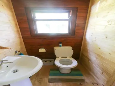 a small bathroom with a toilet and a sink at Mountain Fly Fishing in Magoebaskloof