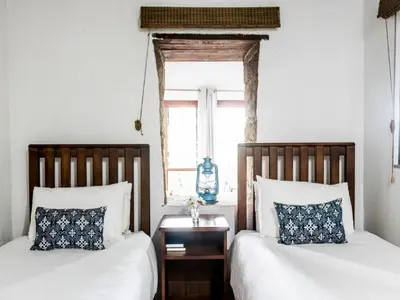 two beds sitting next to each other in a bedroom at Mountain Fly Fishing in Magoebaskloof