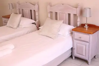 two beds sitting next to each other in a bedroom at Die Huis - Self Catering in Bela-Bela