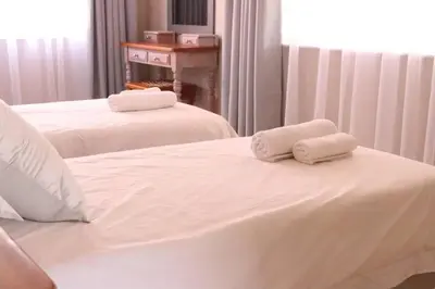 two white towels sitting on top of a bed at Die Huis - Self Catering in Bela-Bela