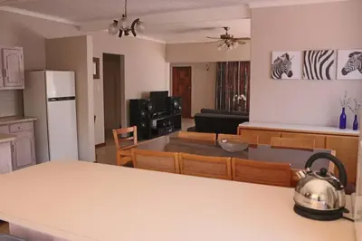 a kitchen and living room with a tea kettle on a counter at Die Huis - Self Catering in Bela-Bela