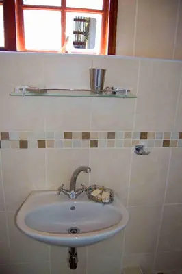 a sink in a bathroom with a window at Suzie's Loft - NUDE - SunEden Family Naturist Resort in Pretoria