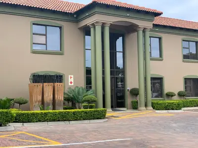 a building with columns in a parking lot at Royal Hotel in Polokwane