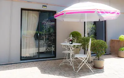 a table and two chairs and an umbrella at Barberton BnB in Barberton
