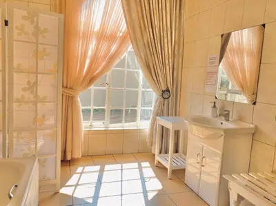a bathroom with a sink and a window at Barberton BnB in Barberton