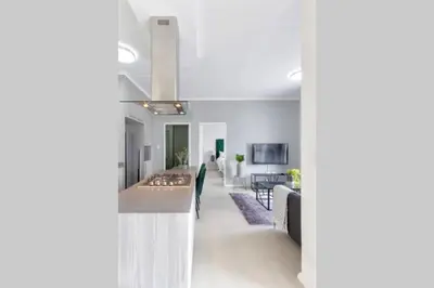 a kitchen and living room with a long hallway at Alimama Spaces: The Manson's 8 On New in Midrand