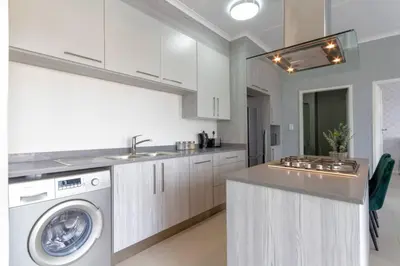 a kitchen with a washing machine and a sink at Alimama Spaces: The Manson's 8 On New in Midrand