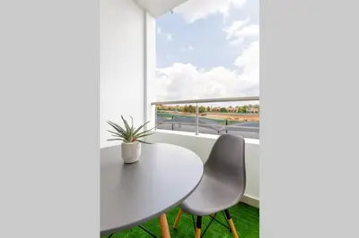 a white table and chairs in a room with a window at Alimama Spaces: The Manson's 8 On New in Midrand