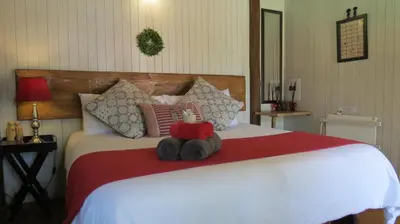 a stuffed animal sitting on top of a bed at Ciara Guesthouse in Pretoria