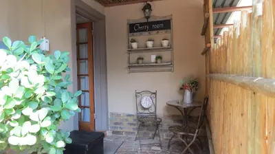 a porch of a house with a sign on the wall at Ciara Guesthouse in Pretoria