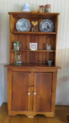 a wooden cabinet with plates on top of it at Ciara Guesthouse in Pretoria
