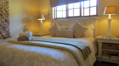 a bedroom with a large bed with a window at Ciara Guesthouse in Pretoria