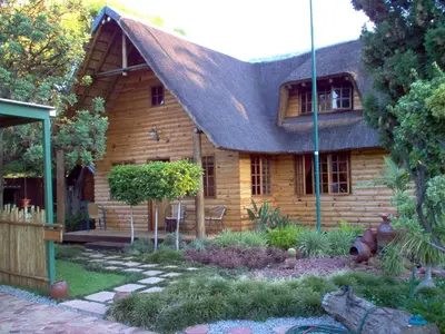 a wooden house with a gambrel roof at Ciara Guesthouse in Pretoria