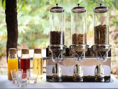 a table with four containers of food and drinks at Kruger Eden Lodge in Marloth Park