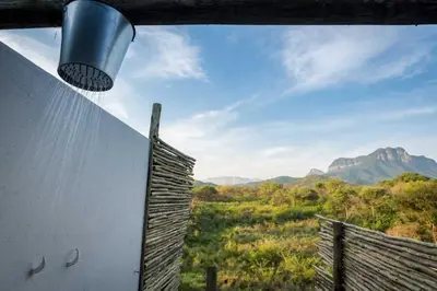 a view of the mountains from a room with a window at Kruger Cliffs Lodge - Absolute privacy guaranteed in Hoedspruit