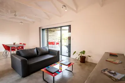 a living room with a black couch and a table at Kruger Cliffs Lodge - Absolute privacy guaranteed in Hoedspruit