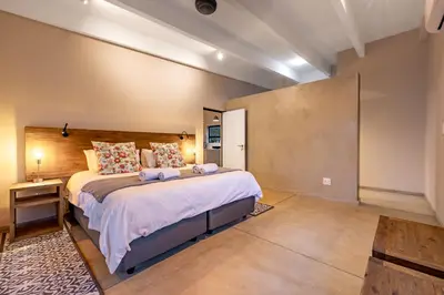 a bedroom with a large bed in a room at 444 on Taaibos Bush Villa in Hoedspruit