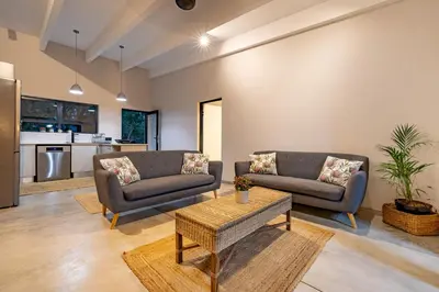 a living room with two couches and a table at 444 on Taaibos Bush Villa in Hoedspruit