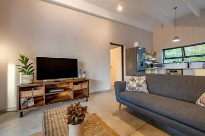 a living room with a couch and a flat screen tv at 444 on Taaibos Bush Villa in Hoedspruit