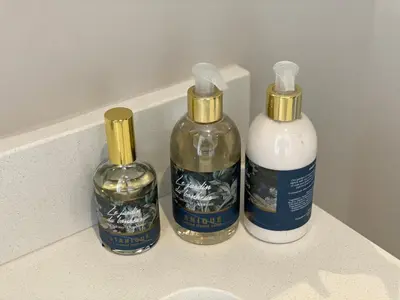 three bottles of disinfectants sitting on top of a counter at Menlyn Maine Residence 11th Floor Apartment in Pretoria