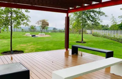 a wooden deck with a bench and a yard at Menlyn Maine Residence 11th Floor Apartment in Pretoria