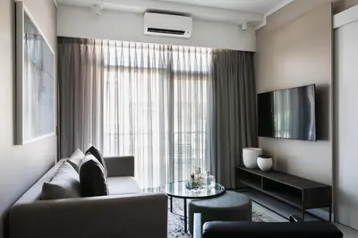 a living room with a couch and a table at The Capital Trilogy Menlyn Maine in Pretoria