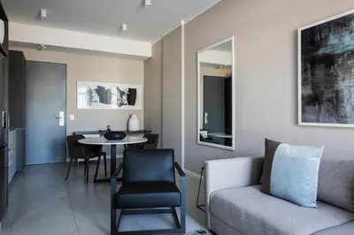 a living room with a couch and a table at The Capital Trilogy Menlyn Maine in Pretoria