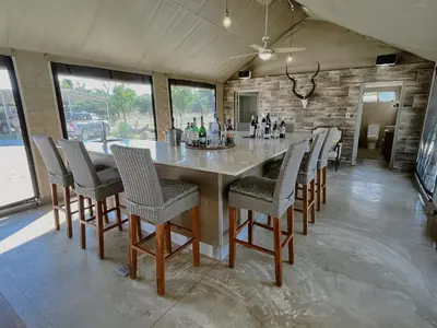 a large dining room with a large table and chairs at Die Boskamp Self-Catering Bush Retreat in Marble Hall