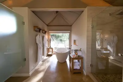 a large bathroom with a tub and a shower at Die Boskamp Self-Catering Bush Retreat in Marble Hall