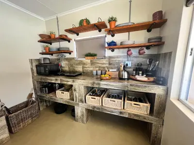 a kitchen with a wooden counter with baskets at Die Boskamp Self-Catering Bush Retreat in Marble Hall