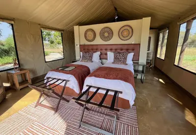 a bedroom with two beds in a tent at Die Boskamp Self-Catering Bush Retreat in Marble Hall