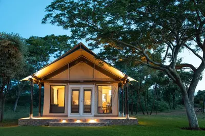 a small house with lights on the grass at Die Boskamp Self-Catering Bush Retreat in Marble Hall