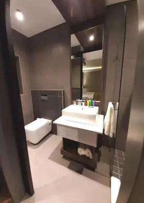 a bathroom with a white sink and a toilet at Copperwood Hotel and Conferencing in Brits
