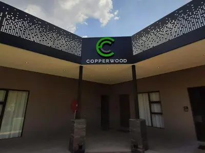 a building with a cyberwood sign on the side of it at Copperwood Hotel and Conferencing in Brits