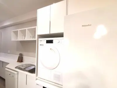 a white kitchen with a washing machine in it at Regency Apartment Hotel Menlyn in Pretoria